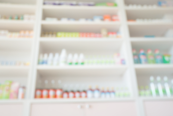 Blurred screen shot of a shelf of items in a pharmacy