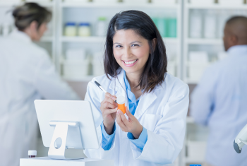 Pharmacist smiling while taking a note 